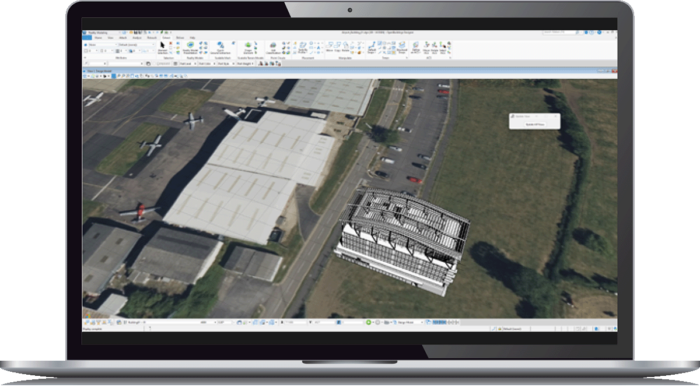Un ordinateur portable affichant Bentley Descartes montre une vue aérienne d'un aéroport avec des bâtiments et des avions, ainsi qu'un rendu 3D d'une structure.