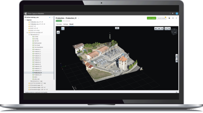 A laptop displaying iTwin Capture Modeler with a digital reconstruction of a small industrial facility on the screen. Various menu options and tools are visible on the interface.