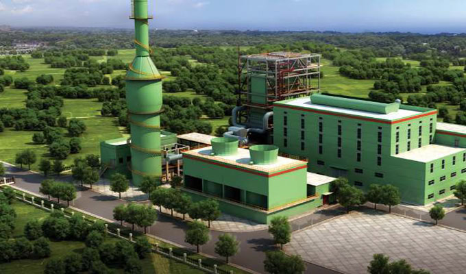 Aerial view of CERI's green industrial plant surrounded by lush greenery, featuring a tall chimney and large building structures that harmoniously integrate sustainability.