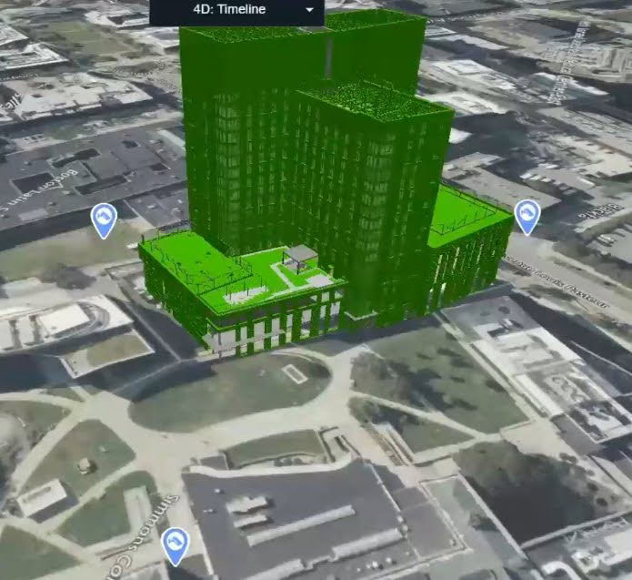 3D rendering of a large, green building model over a satellite map view of a cityscape, showcasing streets and surrounding areas, reminiscent of designs from award winners.