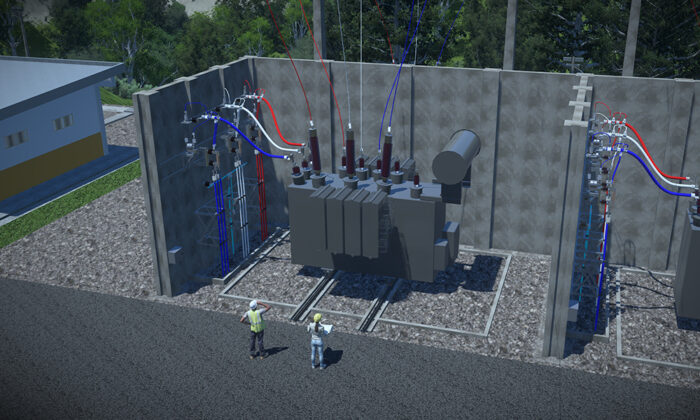 Two workers stand near a large industrial transformer in a fenced outdoor electrical substation surrounded by equipment and wiring.