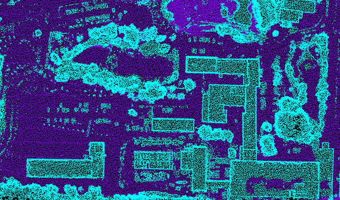 Aerial thermal image showing a landscape with various rectangular structures and irregular shapes, depicted in blue and purple tones.