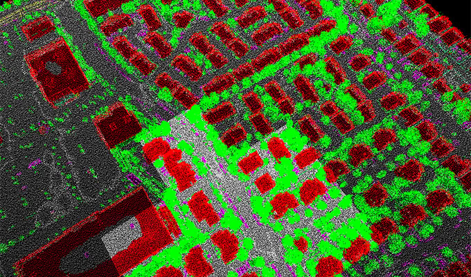 Aerial view of a town using LiDAR point cloud data. Buildings are in red, vegetation in green, and roads in gray.