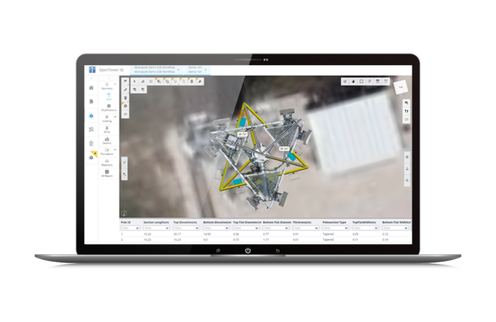 Laptop displaying a 3D model of a telecommunications tower using CAD software, with toolbars on the sides and various data grids below the image.