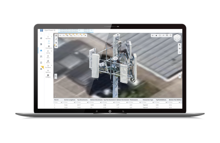 A laptop displays a 3D model of a cell tower on its screen with various tools and data points visible in a software interface.