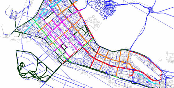 Color-coded street map with grid layout, featuring red, green, blue, and purple lines outlining various routes and zones in the Middle East.