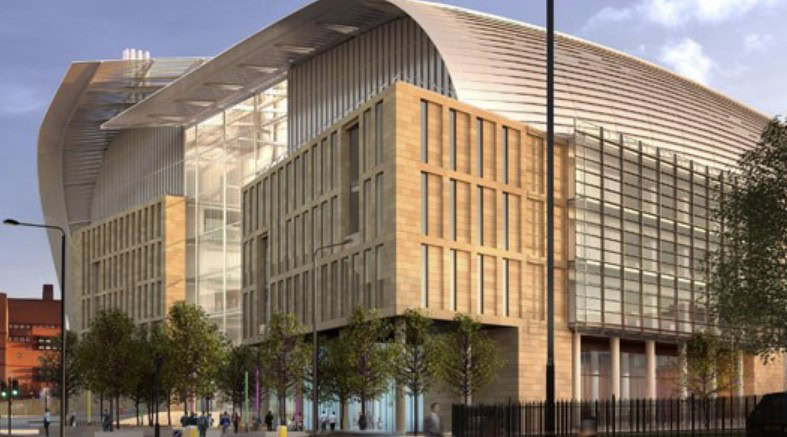 Modern multi-story building with a futuristic curved roof, large glass windows, and a mix of stone and metal facades surrounded by trees and streetlights, reminiscent of the design process used in the Francis Crick Institute.