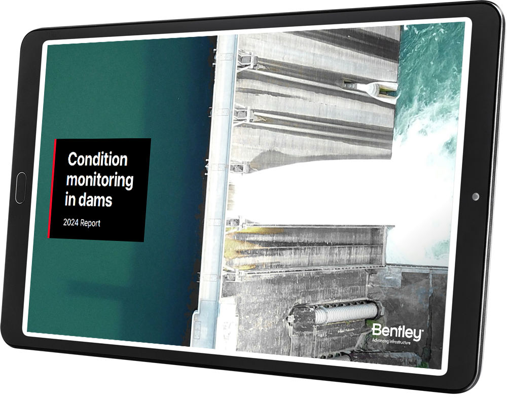 A digital tablet displaying a report cover titled "CMR Dam Report - Condition Monitoring in Dams - 2024 Report" with an aerial image of a dam in operation. The text includes the name "Bentley.