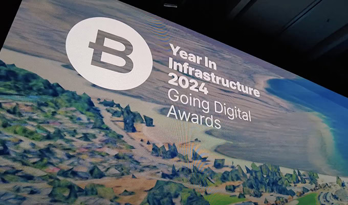 Presentation slide for "Year In Infrastructure 2024: Going Digital Awards" with an aerial view of a landscape and coastline.