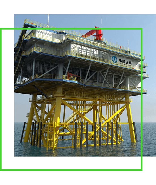 An oil rig in the ocean with a green frame.