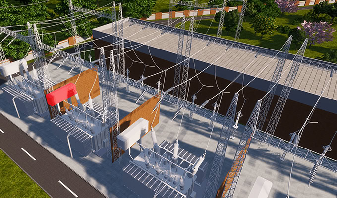 木々や緑に囲まれた道路脇の、金属製の構造物、電線、変圧器などの設備を備えた変電所の空中写真。