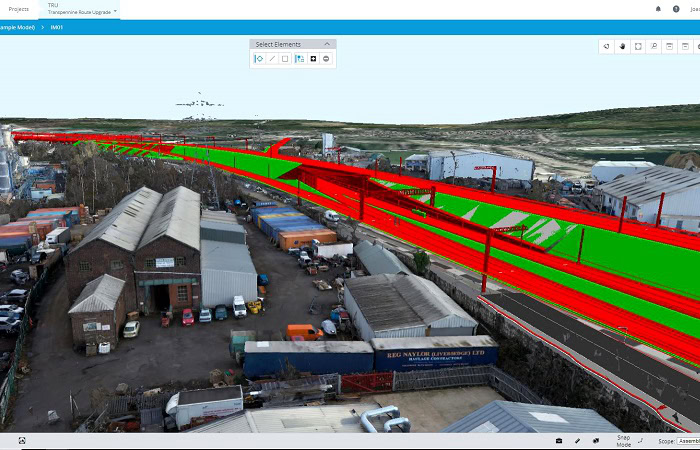 A digital rendering of an industrial area with a 3D overlay, auto-drafted to depict a proposed development of roads and railways in red and green. Various buildings, vehicles, and storage areas are visible.